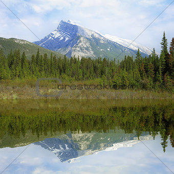 Rundle mountain and its reflection.