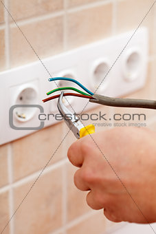 Electrician hands with wires and pliers