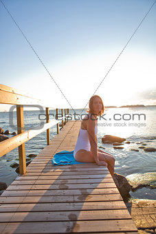 Attractive woman sitting on pier