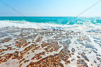 clear sea water and pebble beach
