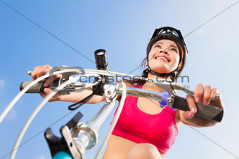 female biker starting to ride with blue sky background