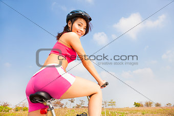 woman biker riding Folding Bicycle and looking back 