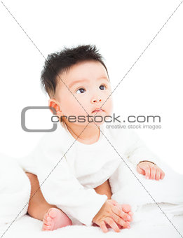cute newborn infant baby sitting and looking