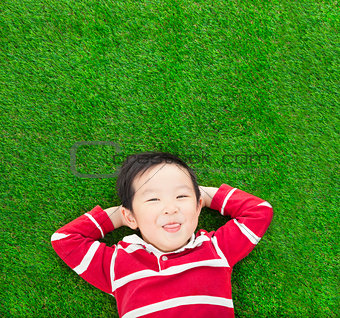 A funny kid lying and holding his head