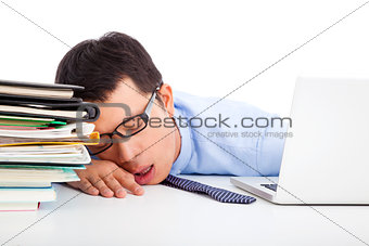 young businessman too weary to asleep on the desk