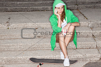 beautiful sexy lady in jeans shorts with skateboard, to-go cup a