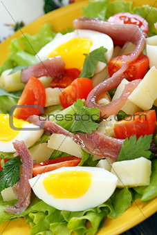 Salad with eggs, cherry tomatoes and anchovies.