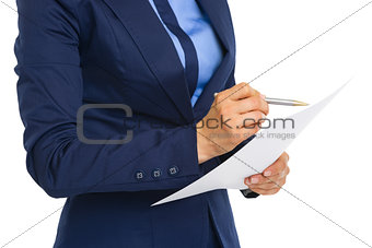 Closeup on business woman examining document