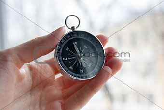 black compass in a female hand