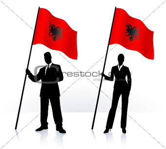 Business silhouettes with waving flag of Albania