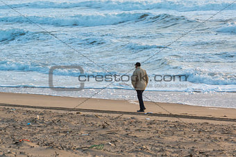 Man Walks Along Coast