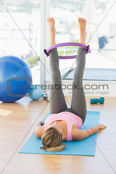 Sporty young woman exercising in fitness studio