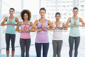 Fit class with hands joined at fitness studio