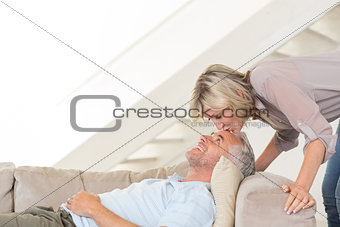 Woman kissing a mans forehead in the living room