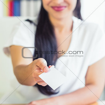 Midsection of businesswoman giving business card