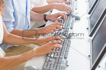 Midsection of customer service agents working at desk