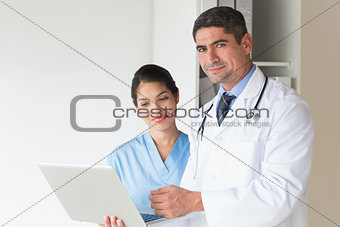 Doctor and nurse with laptop in hospital