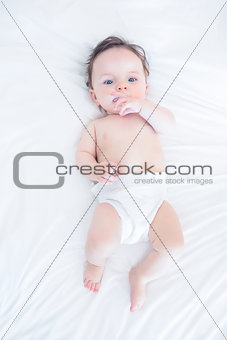 Innocent baby with finger in mouth