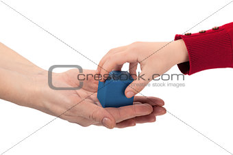 Child grabs blue wooden cube toy from mom's hands isolated on wh