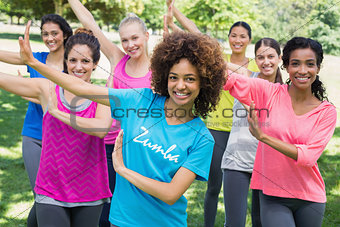 Friends performing Zumba dance in park