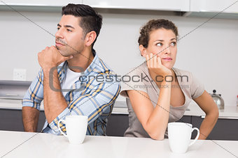 Unhappy couple having coffee not speaking