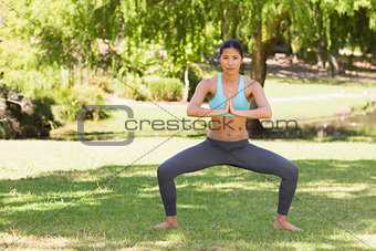 Healthy and beautiful woman with joined hands in park