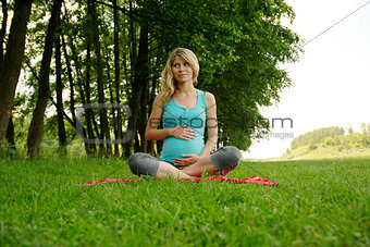 beautiful young pregnant woman in nature