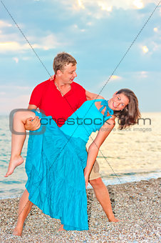 couple embracing and resting on the beach