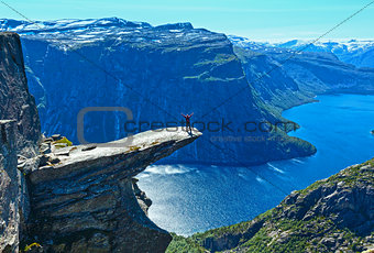Trolltunga summer view (Norway) and man on rocks edge.