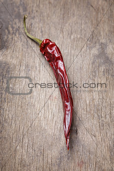 dried red chilli pepper on wood table