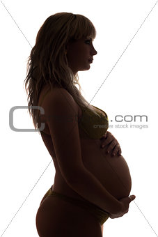 Silhouette of a pregnant young woman