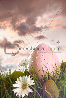 Large pink egg with flowers in tall grass 