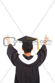  graduation man wearing a mortarboard and raised hands