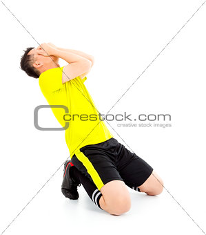 Upset  or excited soccer player kneeling down