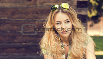 Portrait of Blonde Woman at the Wooden Wall