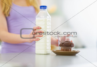 Closeup on young woman with milk and chocolate muffin