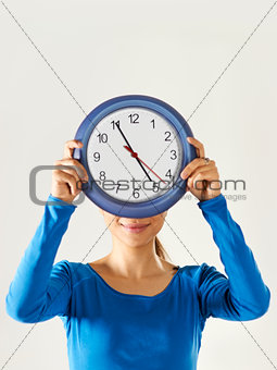 happy asian girl holding big blue clock