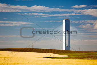 Solar Tower with rays  - thermo-solar power - blue sky and yello