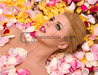 Flower Petals Spread out as Bedding for Beautiful Blond Woman