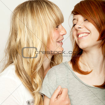 blond and red haired girls are laughing