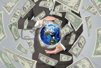 Businessman in a suit holding a earth