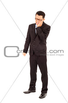 young businessman standing and in agony with a toothache