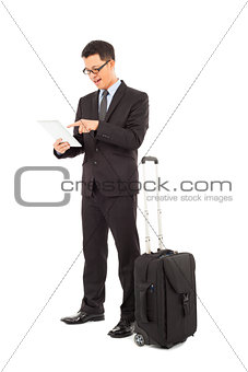 Young businessman using a tablet  with briefcase 