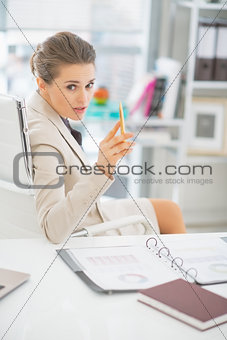 Business woman discussing in office and pointing in camera
