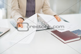 Closeup on clueless business woman with documents