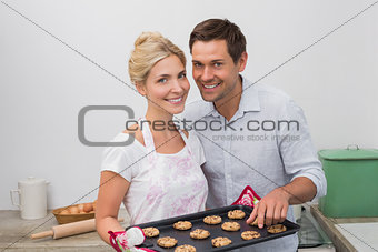 Young couple preparing cookies together in the kitchen