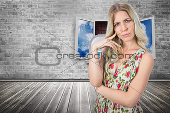 Composite image of frowning pretty blonde wearing flowered dress posing