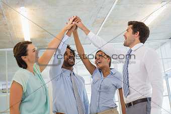 Business team joining hands together in office