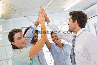 Business team joining hands together in office