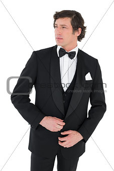 Thoughtful groom in tuxedo getting ready